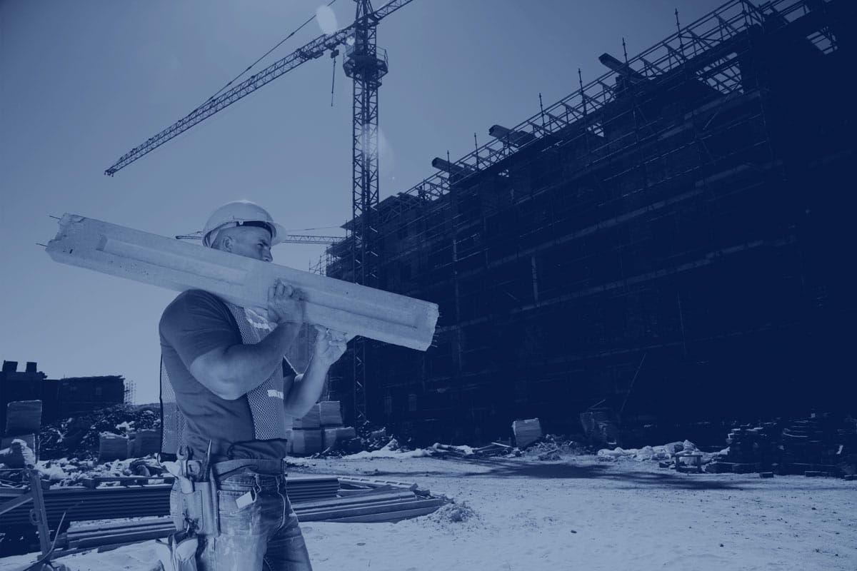 Construction Worker carrying building material