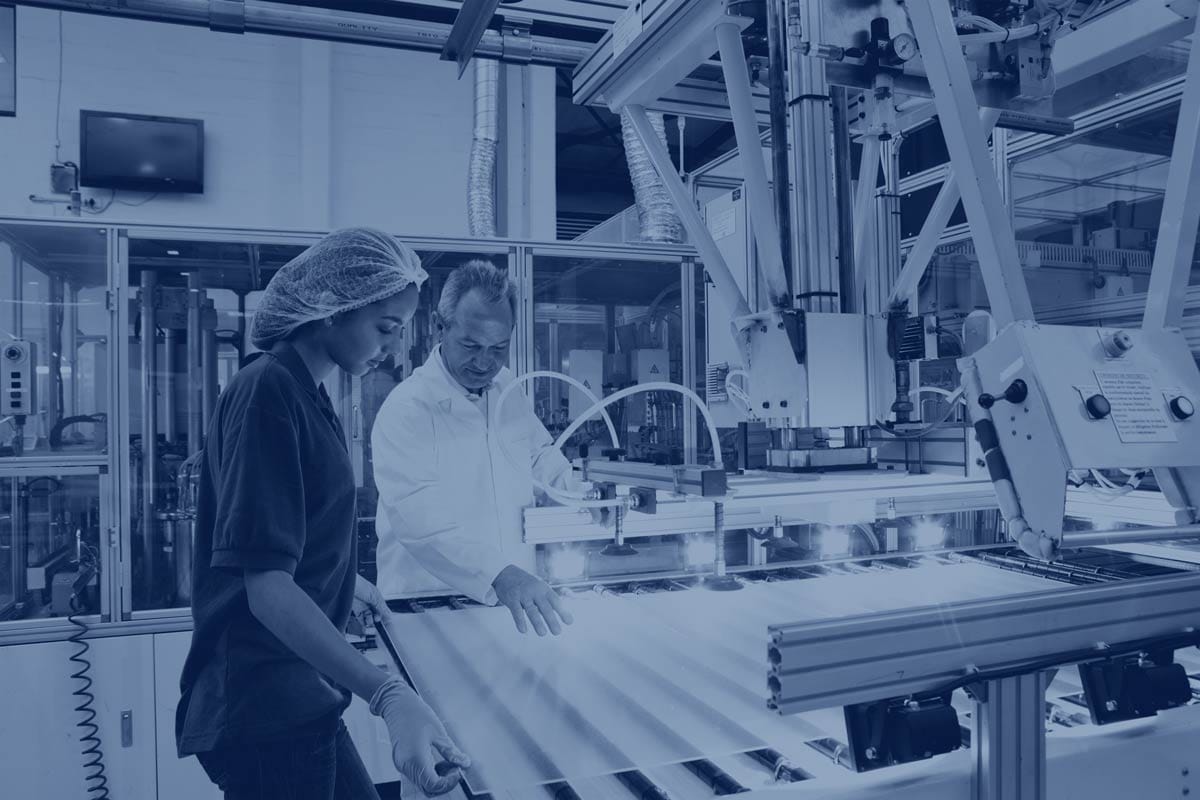 Manufacturing center with 2 workers working on machine